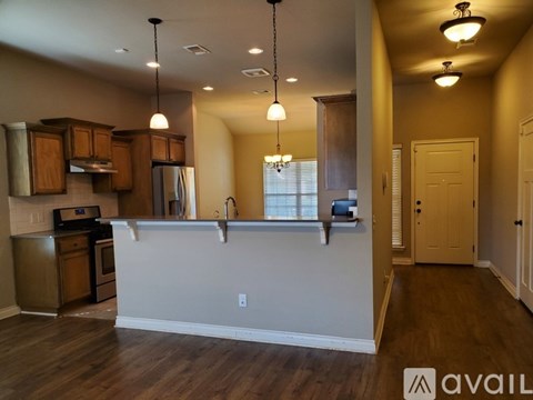A kitchen with wooden cabinets and a white countertop.