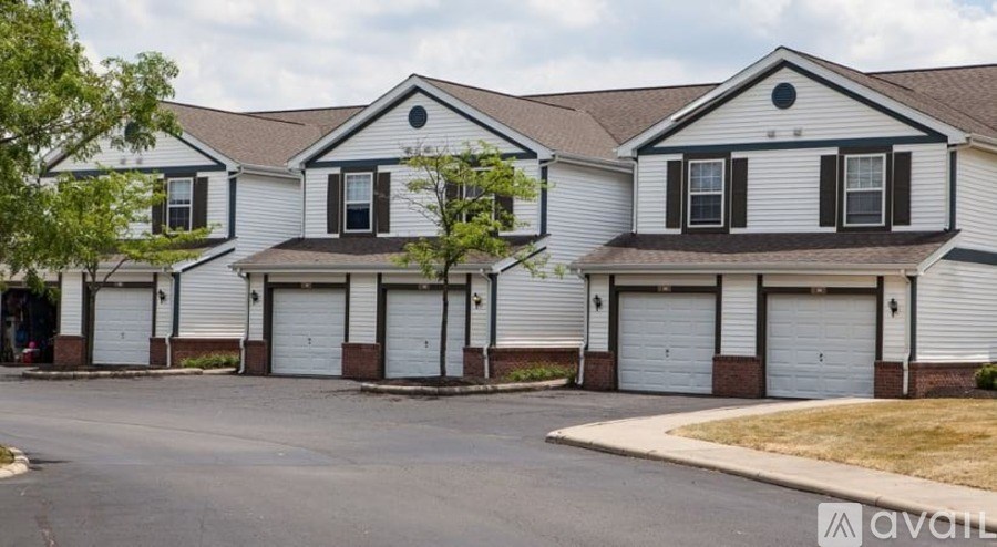 A row of houses with garages in front.