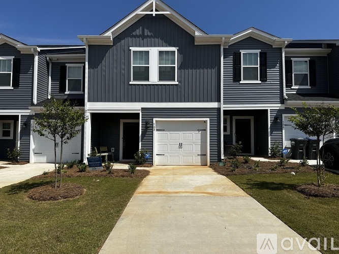 A modern two-story house with a garage and a driveway.