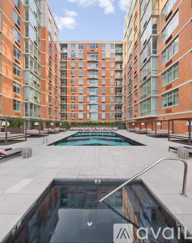 A large pool in the middle of a courtyard surrounded by buildings.