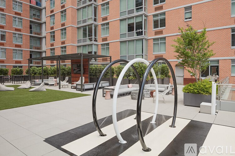 A modern outdoor seating area with a black and white checkered floor.