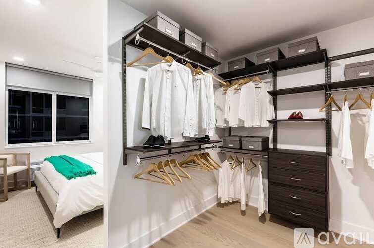 A bedroom with a bunk bed and a chair.