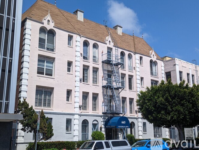 A white building with a blue awning and the number 666 on it.