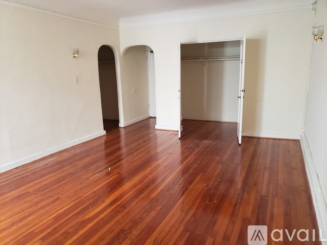 A room with wooden floors and white walls.