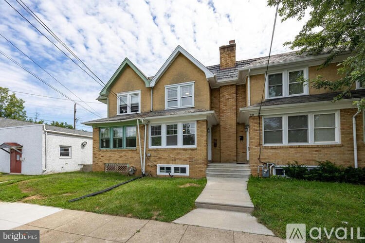 A house with a brown brick exterior and a white garage door.