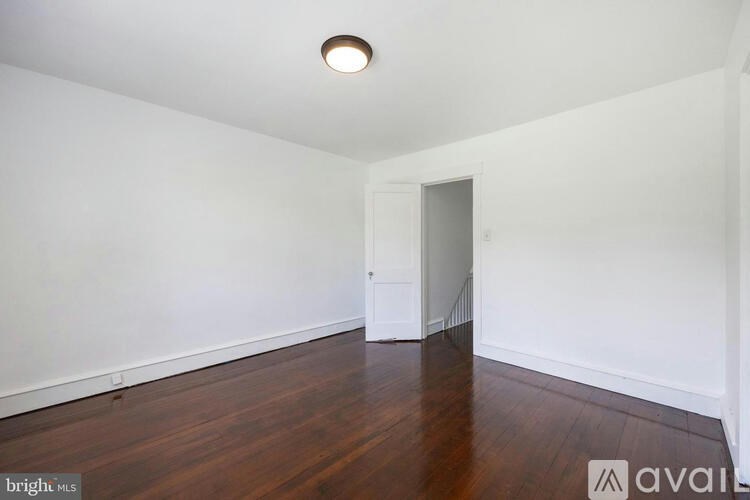 A room with wooden floors and white walls.