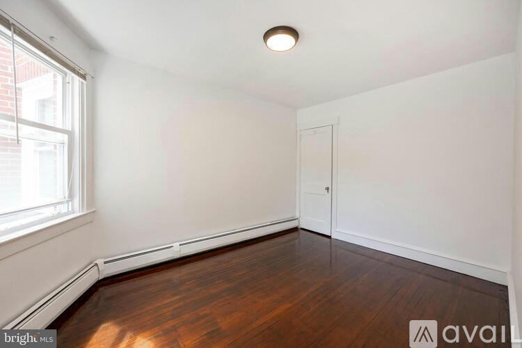 A room with wooden floors and white walls.
