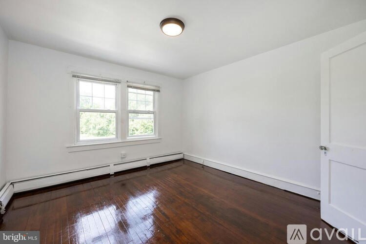 A room with a window and wooden floors.