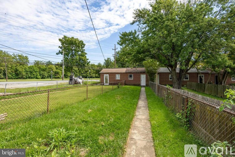 A residential area with houses and a fence.