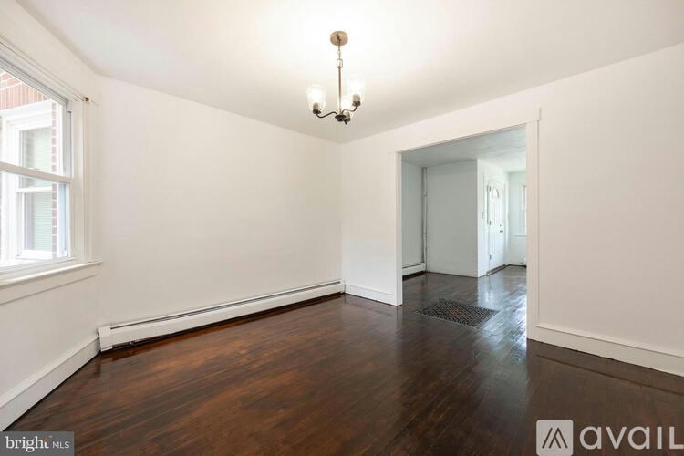 A room with wooden floors and a chandelier.