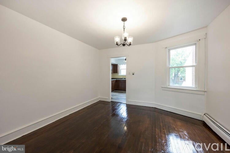 A room with wooden floors and a chandelier.