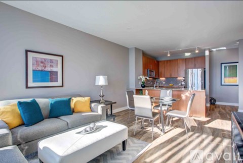 A living room with a grey couch and a white coffee table.
