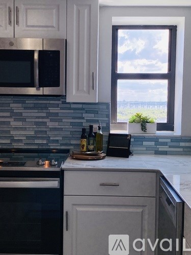 A kitchen with a black oven and a black microwave above it.