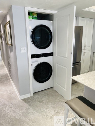 A white front loading washing machine is in a laundry room.
