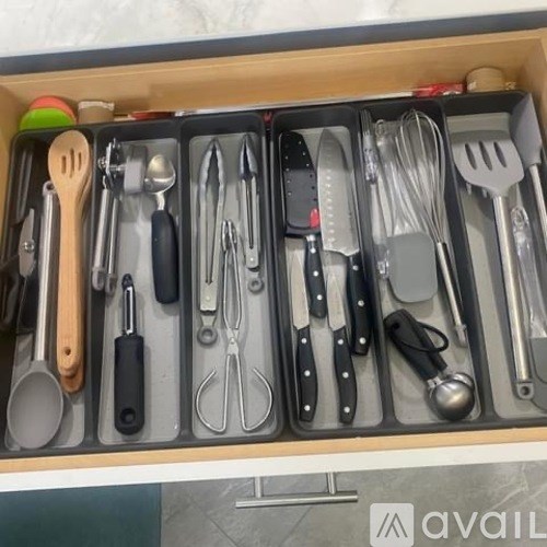 A drawer full of various utensils and kitchen tools.