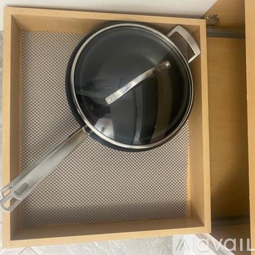 A metal pot sits inside a wooden box.