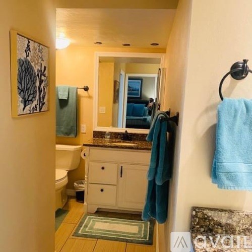 A bathroom with a towel hanging on the towel rack.