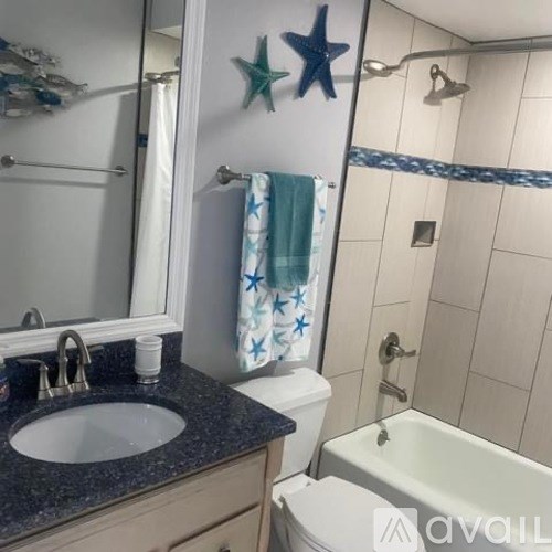 A bathroom with a sink, toilet, and shower.