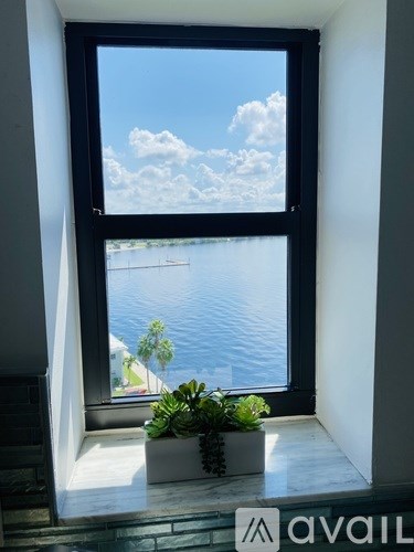 A window with a view of the water and sky.