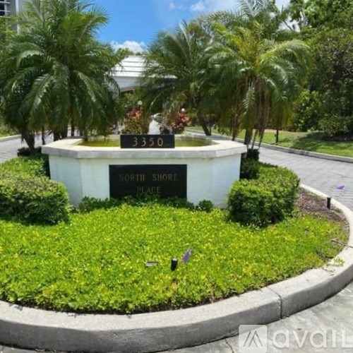 A sign that says North Shore Place stands in a landscaped garden.