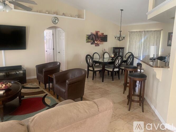 A living room with a brown leather couch and a wooden coffee table.
