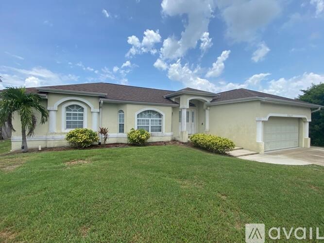 A house with a well-maintained lawn and a clear sky.