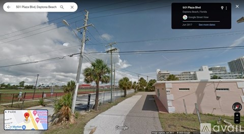 A street view of 501 Plaza Blvd, Daytona Beach with a clear sky and some clouds.
