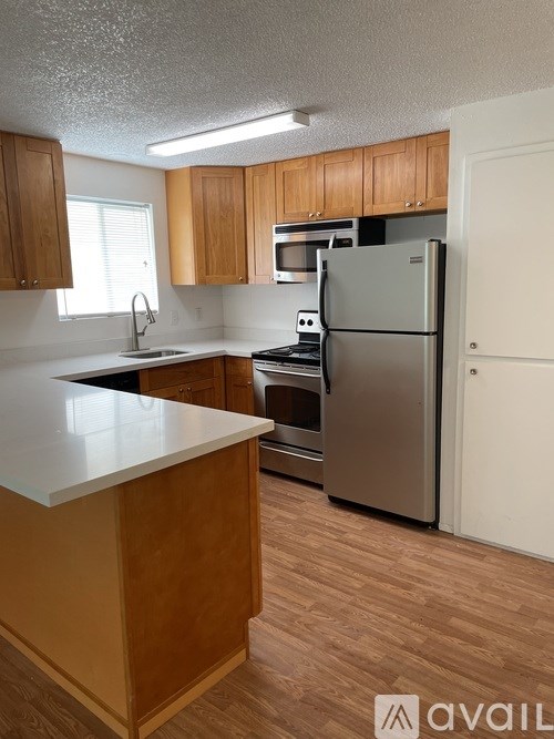 A kitchen with wooden cabinets and a white countertop.