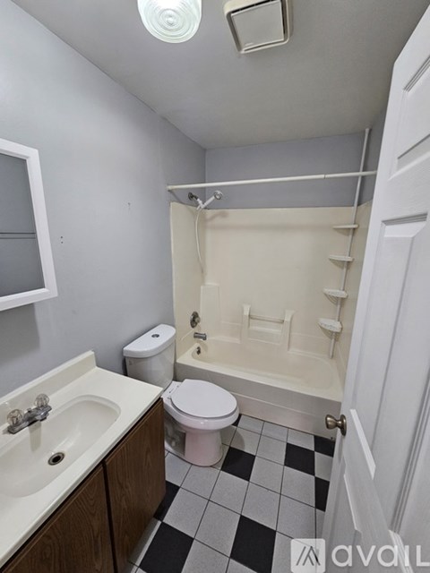A bathroom with a toilet, sink, and bathtub.