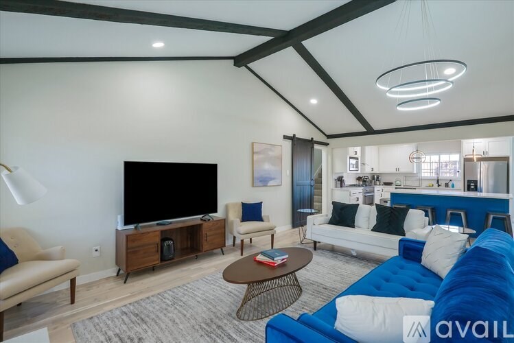 A living room with a blue couch and a television.