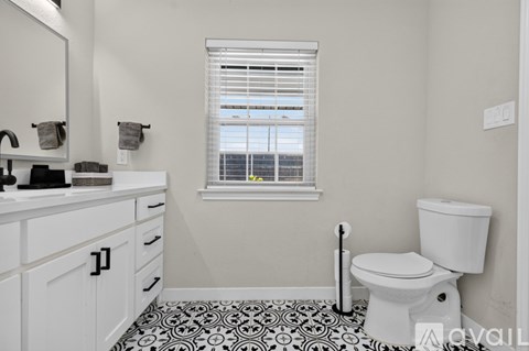 A bedroom with two beds and a ceiling fan.