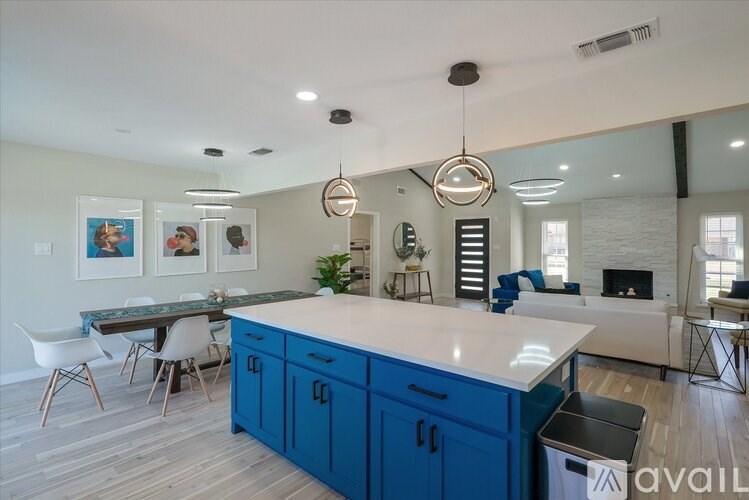 A kitchen with blue cabinets and a white countertop.