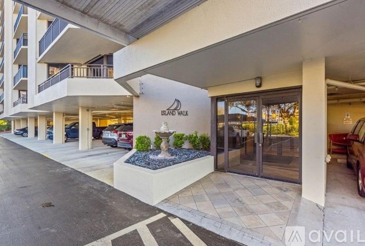 The Island Walk building has a fountain in front of it.