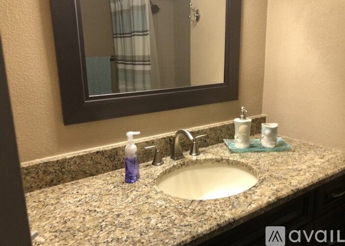 A bathroom sink with a mirror above it.