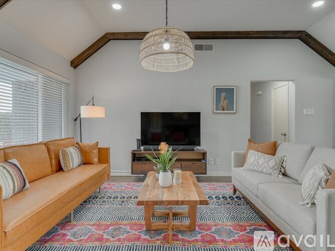 A living room with a wooden coffee table and two couches.