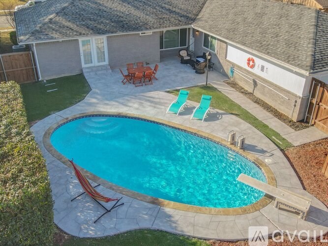 A small residential pool with a hammock.