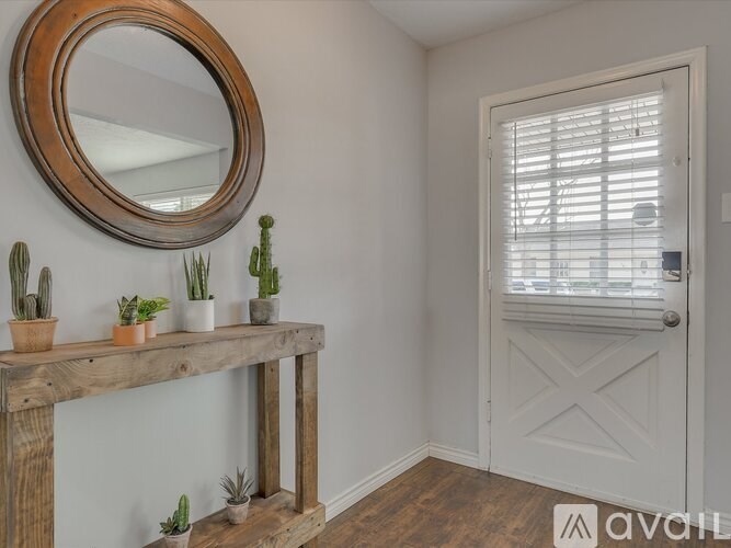 A wooden table with a mirror and potted plants on it.