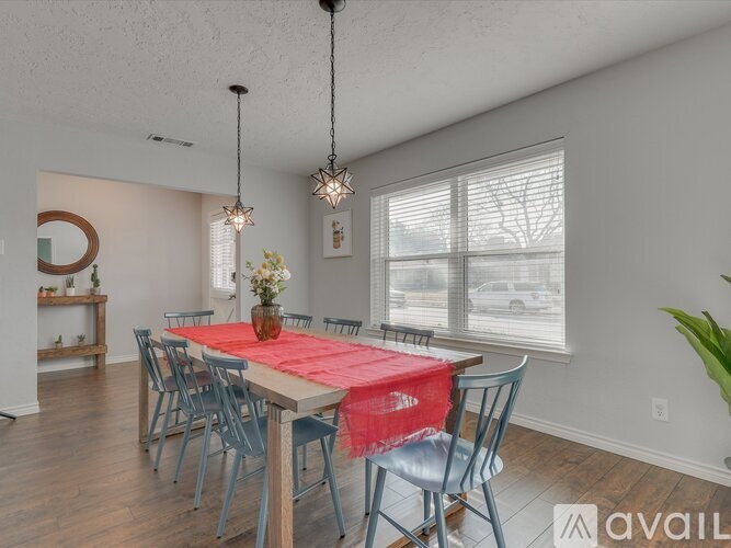 A dining room with a table set for six.