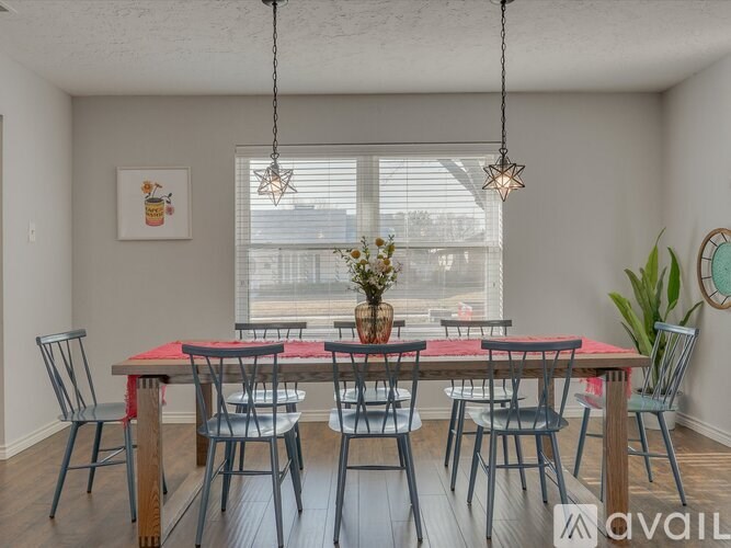 A dining room with a table set for four.