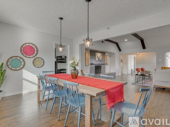 A dining room with a long table and chairs.