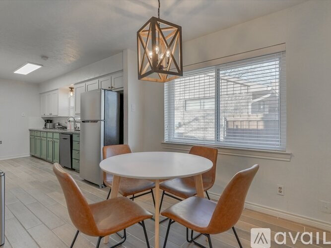 A modern kitchen with a table and chairs.