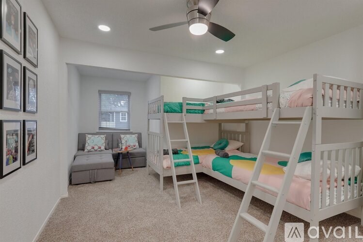 A room with bunk beds and a ceiling fan.