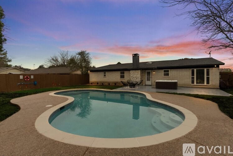 A house with a pool in the backyard.
