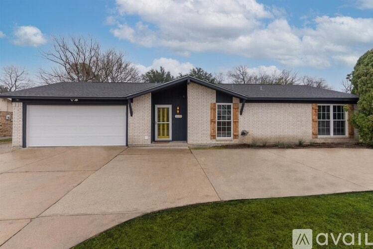 A house with a grey roof and a black garage door.