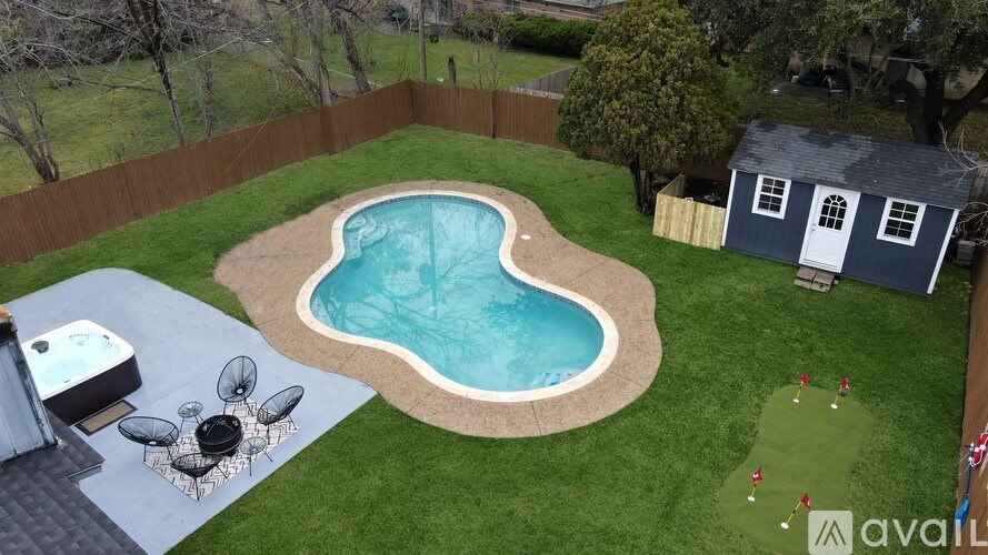 A backyard with a pool and a hot tub.