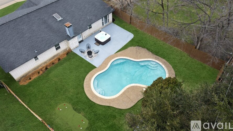 A backyard with a pool and a hot tub.