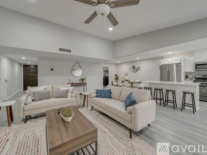 A living room with a couch, coffee table, and bar area.