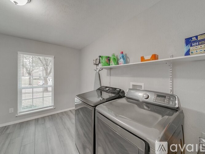 A small laundry room with a washer and dryer.