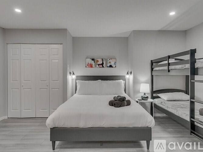 A bedroom with a large bed and a bunk bed.