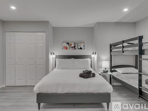 A bedroom with a large bed and a bunk bed.